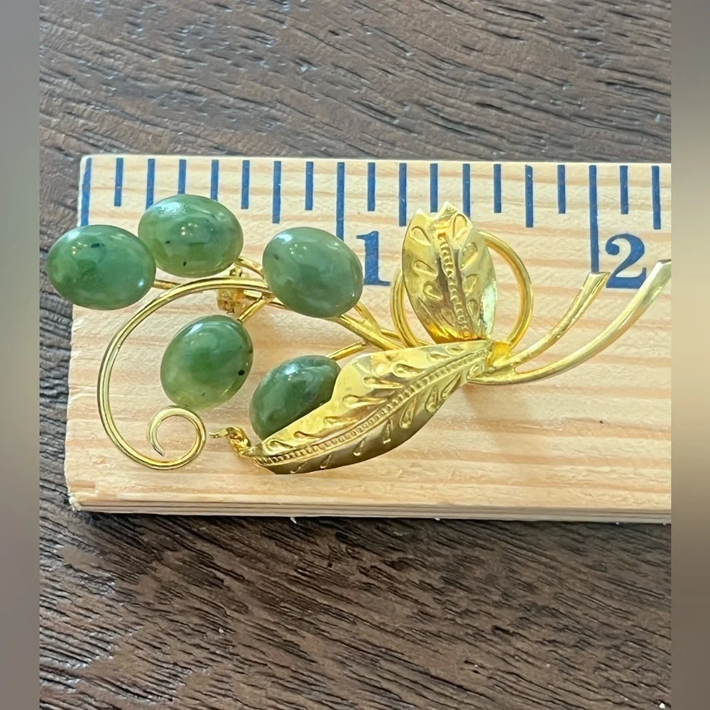 Vintage plated brooch with vines and engraved leaves.
